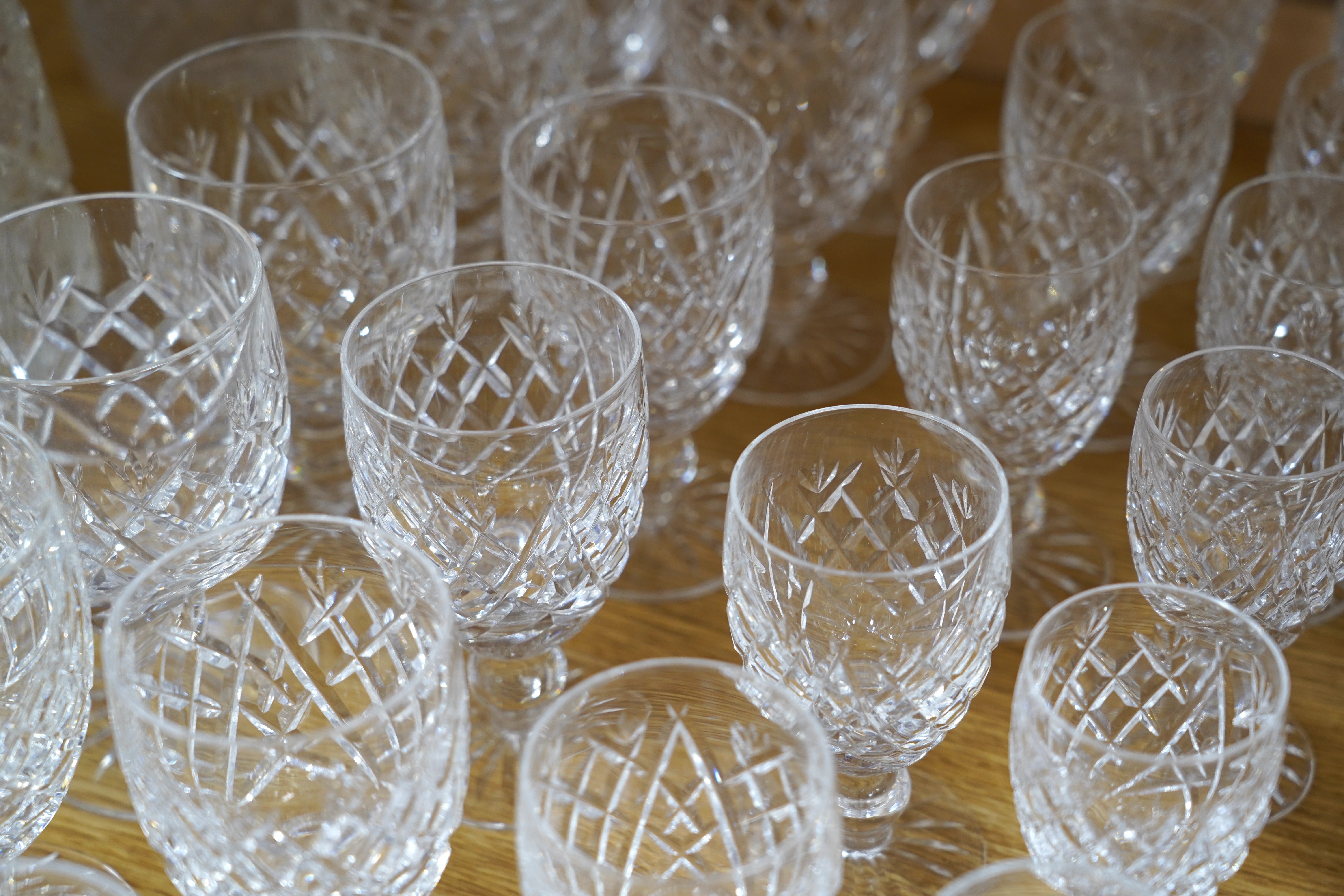 A suite of Waterford drinking glasses in various sizes, including wine glasses, liqueur glasses, champagne glasses, etc. together with glass vases and jugs, etc. (66)